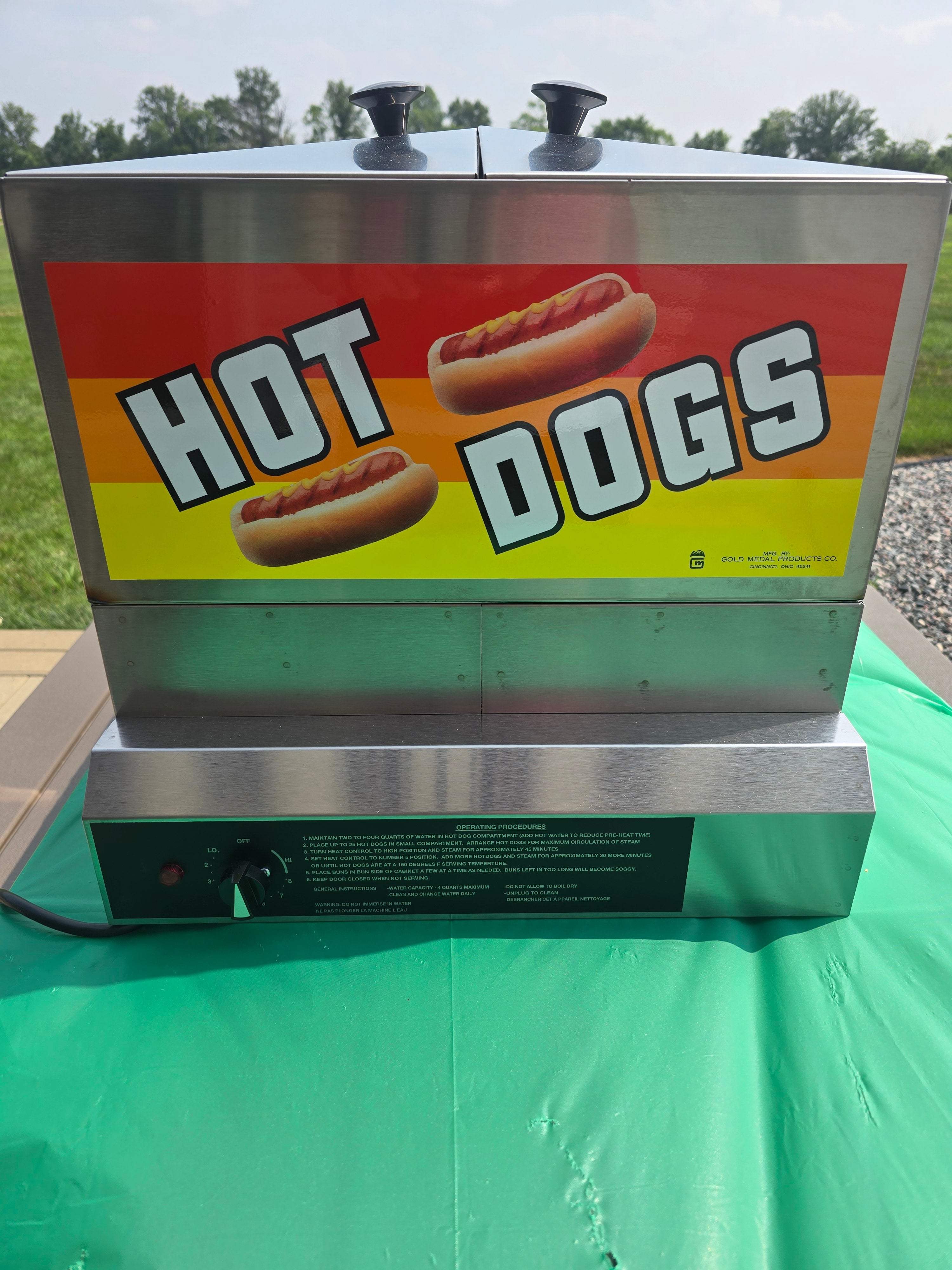 Commercial hot dog steamer rental with Hot Dogs signage